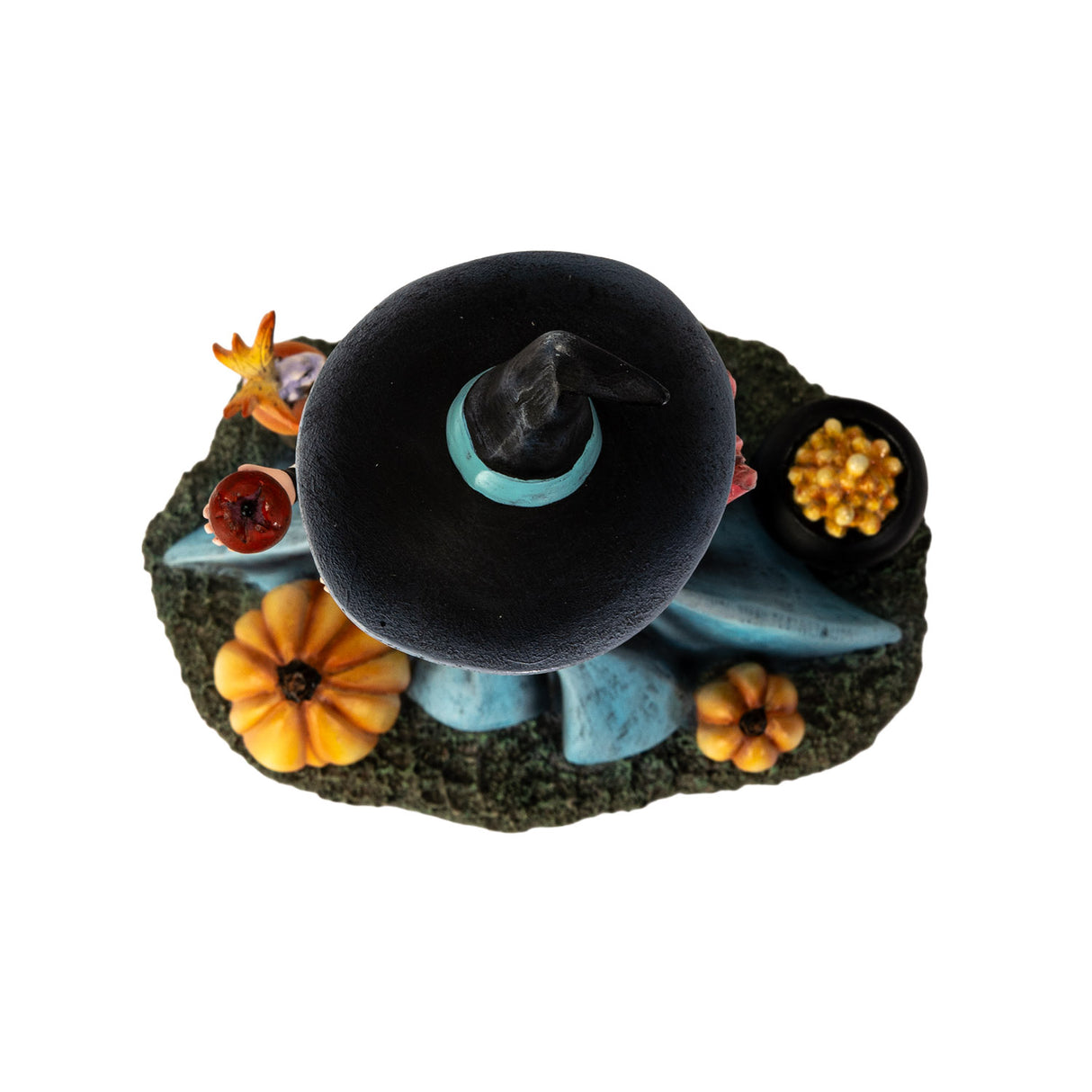 Figurine of witch holding apple, at her feet are pumpkins, fairy frog, cauldron of fruit. Shown top down