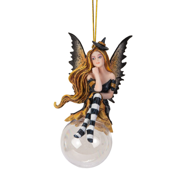 Fairy ornament with witch-themed attire perched on a glass bubble