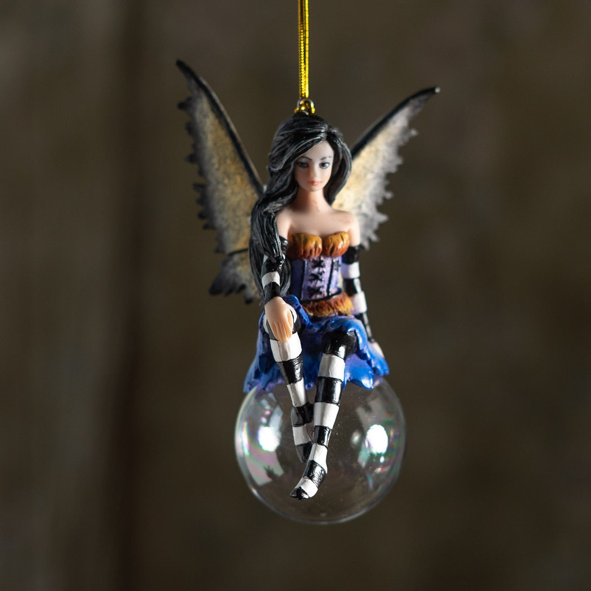 Fairy ornament, black hair, purple and orange outfit with black and white striped sleeves & stockings, tan and black wings, perched on glass bubble