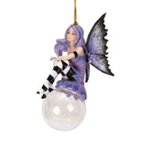 Fairy ornament with purple hair and dress, gray wings, black and white striped stockings, perched on glass bubble