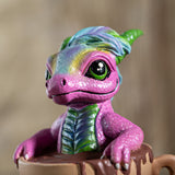 Colorful dragon figurine with a pink-purple body and green accents 