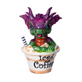 Dragon figurine sitting in an 'Iced Coffee' cup with a straw on a white background