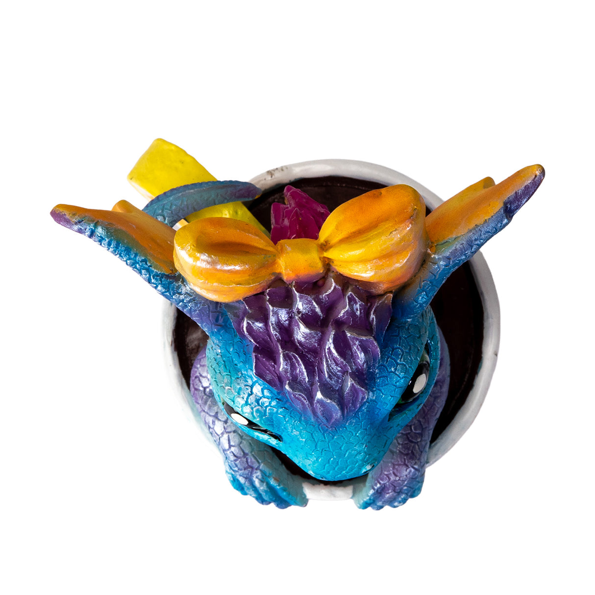 Colorful blue and orange dragon figurine in a glass, shown top down