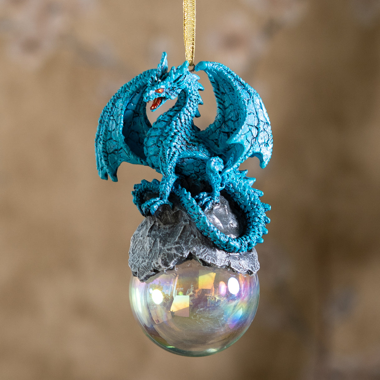 Blue dragon ornament on rock on glass orb