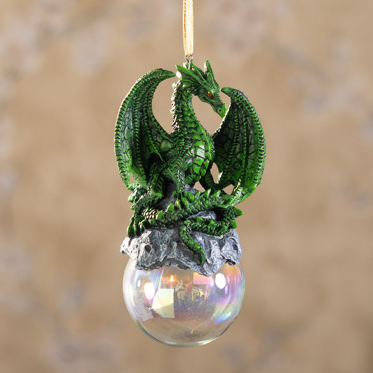 Green dragon ornament on rocks on a glass orb