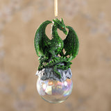 Green dragon ornament on rocks on a glass orb