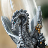 Closeup of gray dragon, blue eye, gold hilt of sword, glass goblet