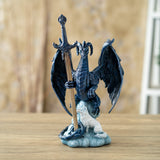 Blue dragon figurine holding a sword letter opener with a white wolf at its feet