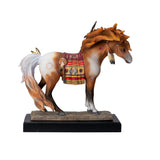 A decorative figurine of a horse standing on a black base with a gold plaque reading 'Medicine Horse.' The horse is a chestnut and white pinto with a multicolored saddle blanket and feather details in a Native American style