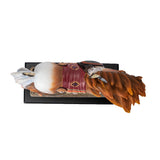 A decorative figurine of a horse standing on a black base with a gold plaque reading 'Medicine Horse.' The horse is a chestnut and white pinto with a multicolored saddle blanket and feather details in a Native American style. Shown top down