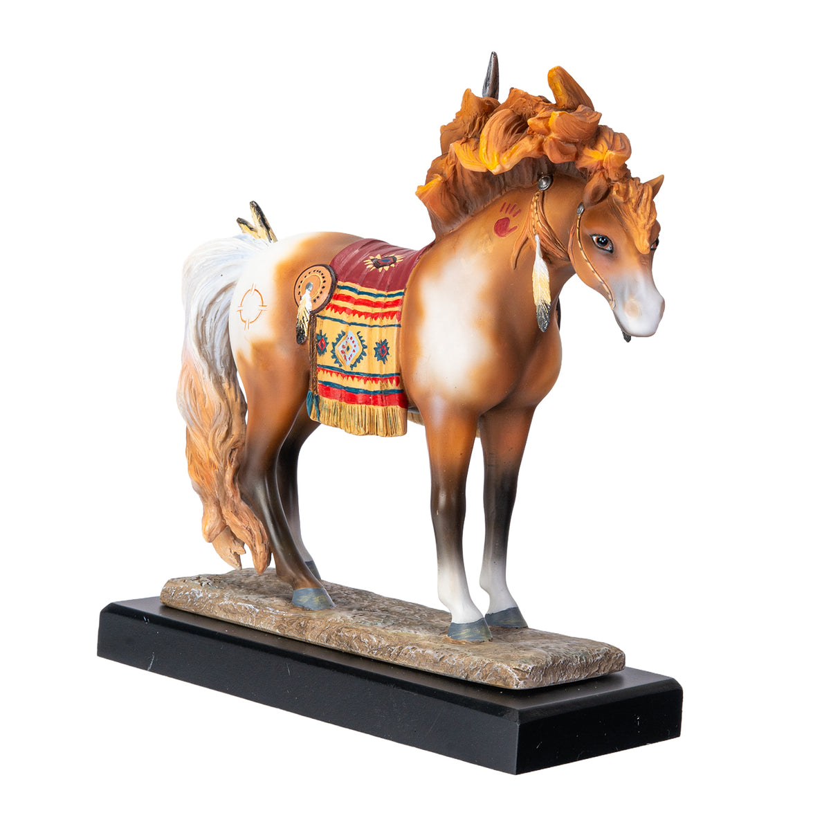A decorative figurine of a horse standing on a black base with a gold plaque reading 'Medicine Horse.' The horse is a chestnut and white pinto with a multicolored saddle blanket and feather details in a Native American style