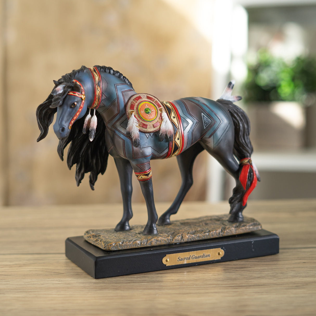 Horse figurine labeled "Sacred Guardian" with southwestern patterns, accessories and feathers