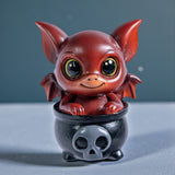 Red dragon imp in a black cauldron figurine