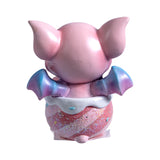 Pink dragon in a striped cauldron with glitter, shown from the back