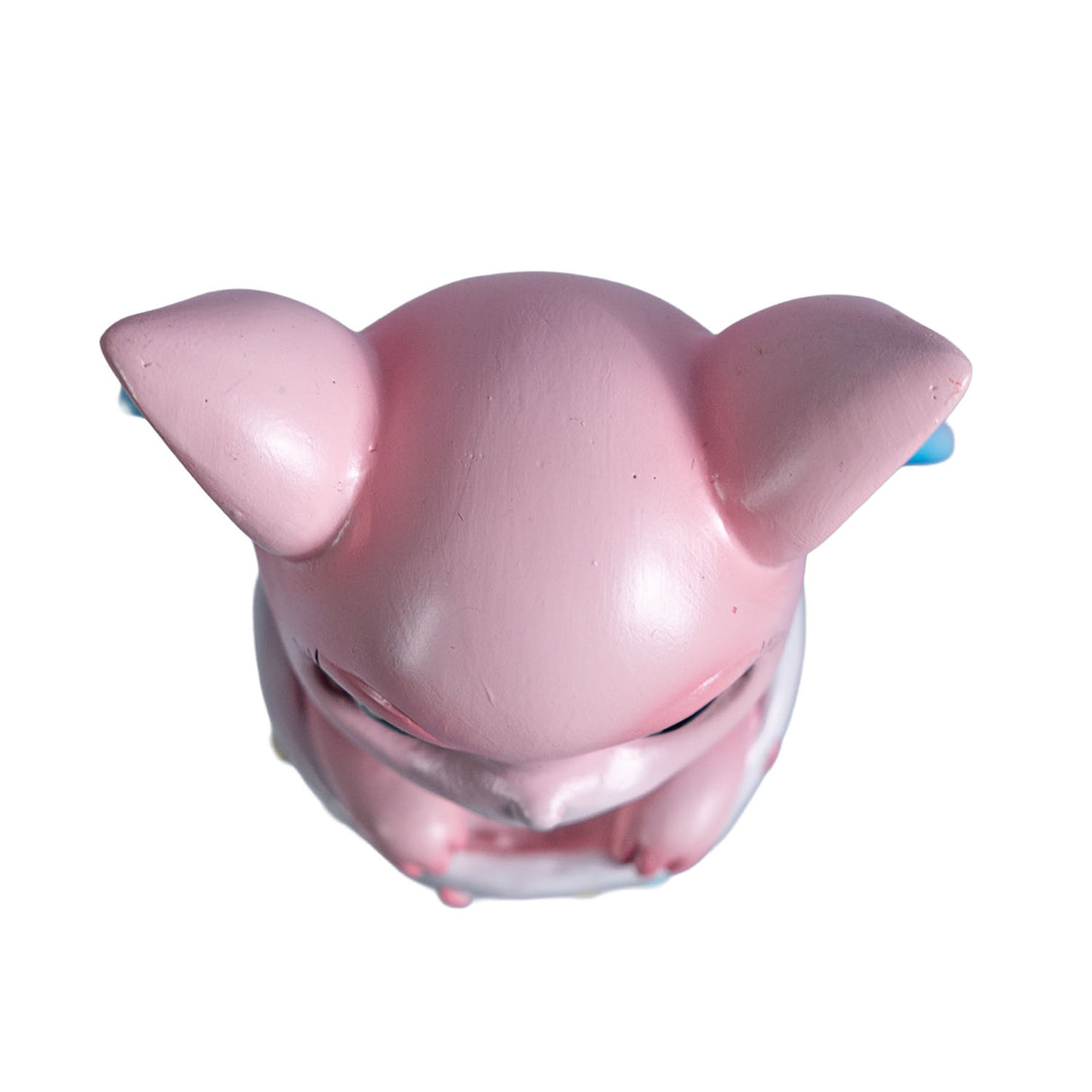 Pink dragon in a striped cauldron with glitter, shown top down