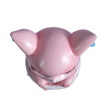 Pink dragon in a striped cauldron with glitter, shown top down