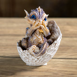 Dragon figurine hatching from an egg 