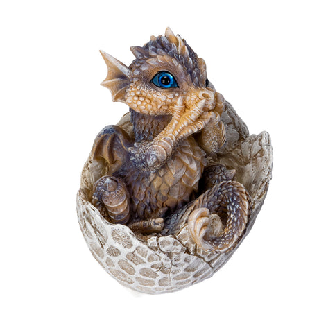 Dragon figurine hatching from an egg on a white background