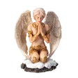 Figurine of a pale-haired angel praying in the snow with white feathered wings and golden swirl accents