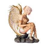 Figurine of a nude angel in gold accents with pale hair and white wings