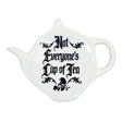 A white ceramic teapot-shaped spoon rest with the phrase 'Not Everyone's Cup of Tea' printed in black gothic lettering and a small skull graphic, shown on a plain white background.