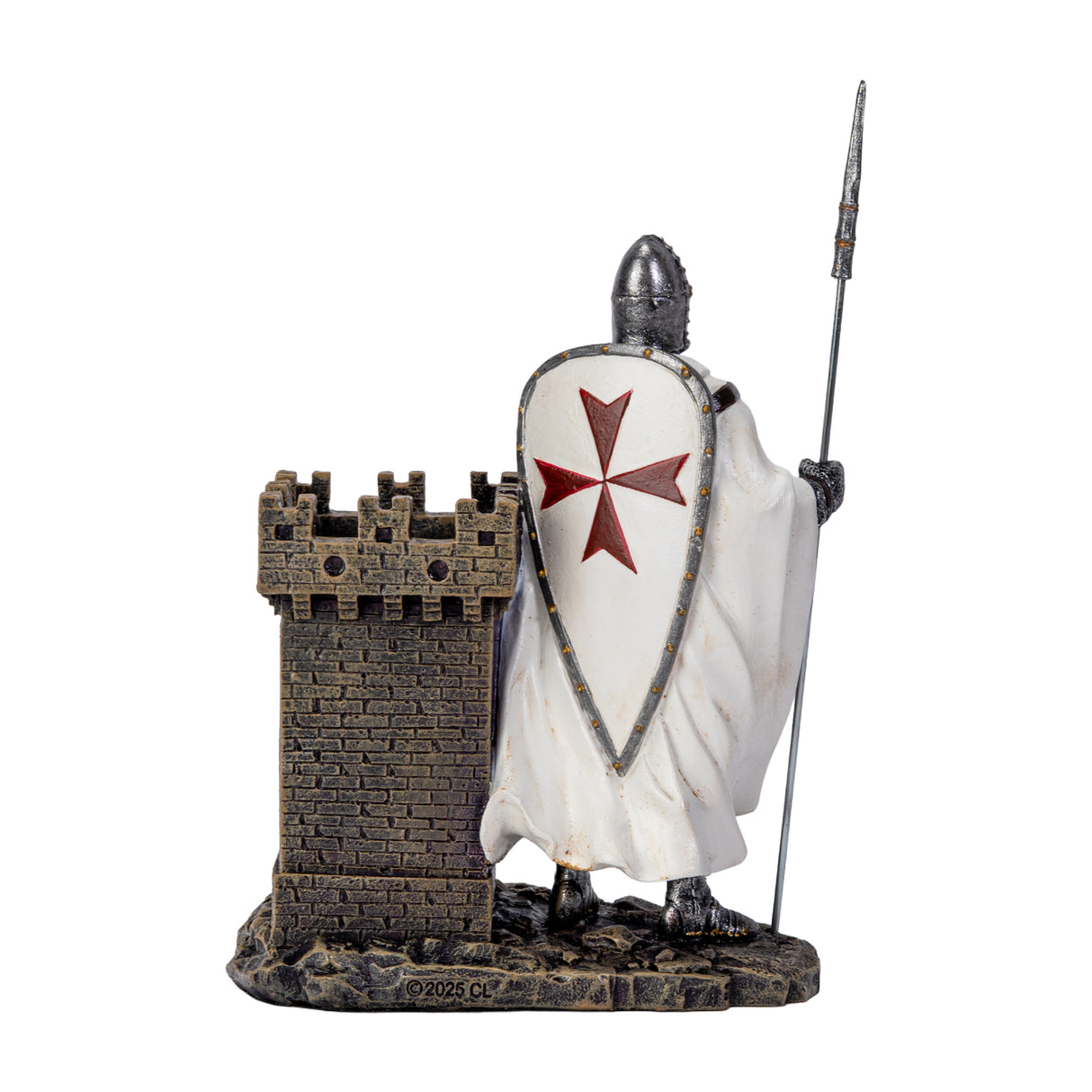 A medieval Templar knight figurine in chainmail and white shield with a red cross, holding a spear next to a small stone castle tower  that doubles as a utility desk caddy/pen holder, shown from the back