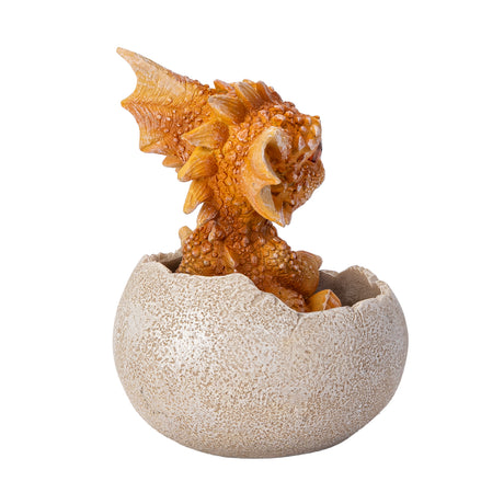 A small orange-brown dragon figurine peeking out of a cracked beige egg, shown from the back
