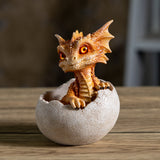 A small orange-brown dragon figurine peeking out of a cracked beige egg, with fiery eyes