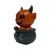 Orange pumpkin-head imp in a black cauldron with moons