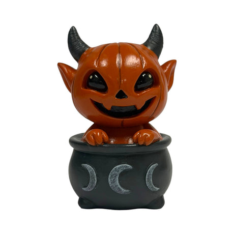 Orange pumpkin-head imp in a black cauldron with moons