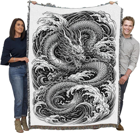 Tapestry blanket in black and white with water dragon, held by two adults
