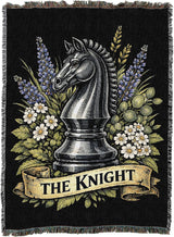 Decorative blanket with a knight chess piece and floral design on a black background