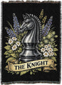 Decorative blanket with a knight chess piece and floral design on a black background