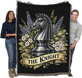 Blanket with a knight chess piece design held by two people