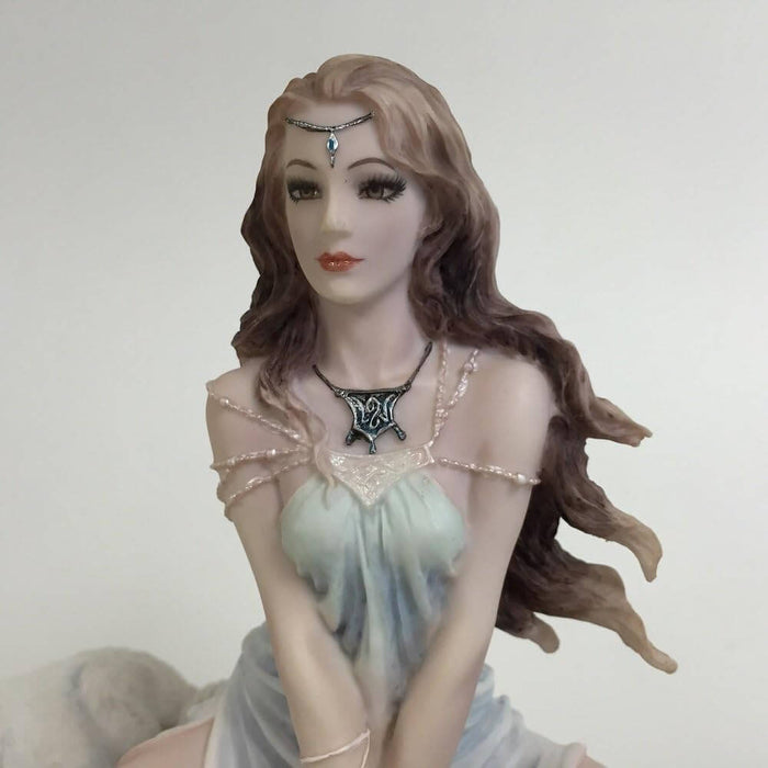 Closeup of brown haired elf with white dress and metallic jewelry