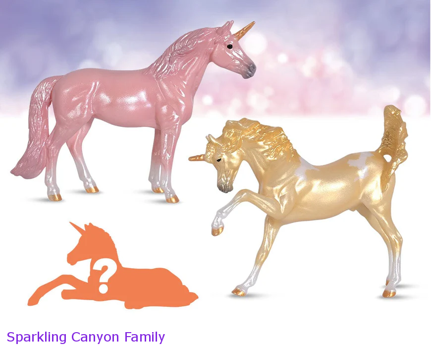 Breyer Unicorn Foal Surprise toy set set with two adult unicorns and hidden foal figurine. Shown models are pink and a yellow pinto, the Sparkling Canyon Family