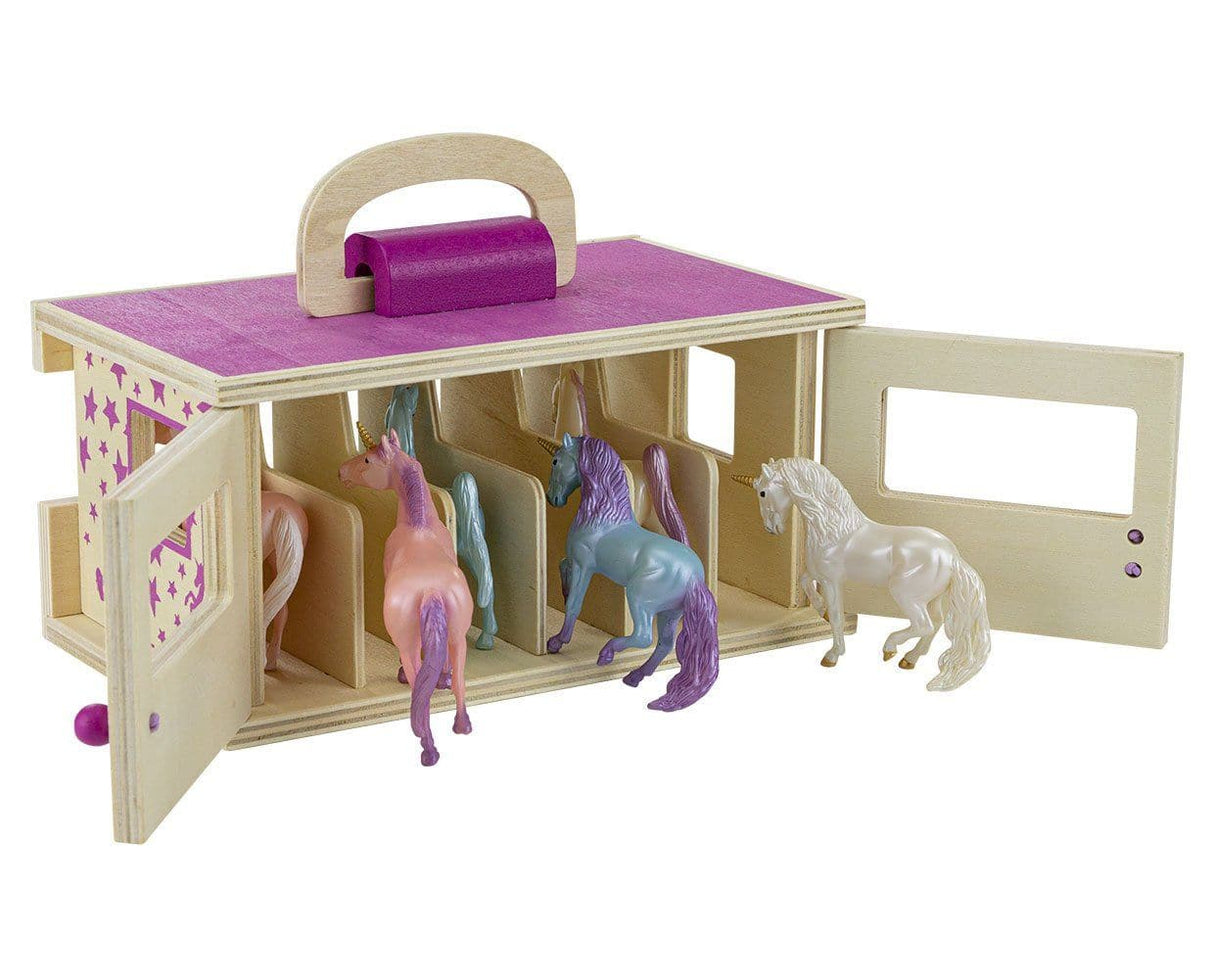 Breyer toy horse carrier with unicorn figurines, shown open from the back