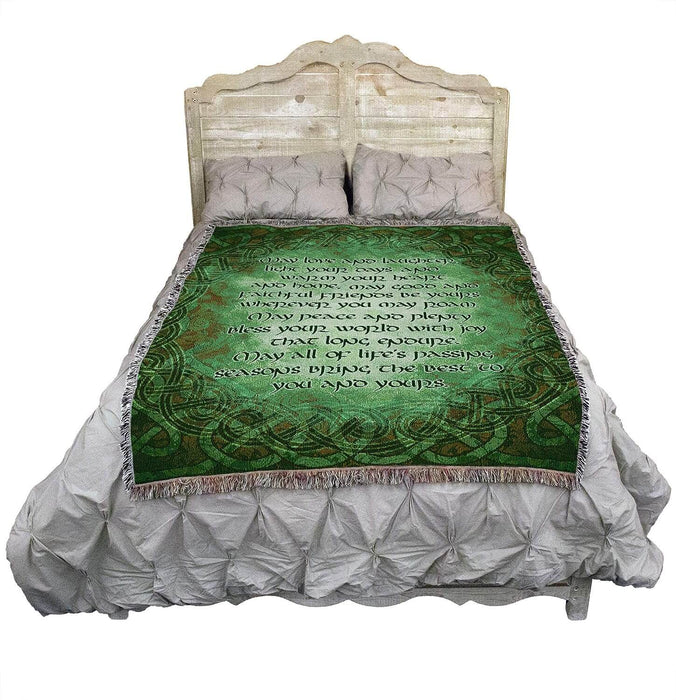 Celtic blessing tapestry blanket in green shown on a bed