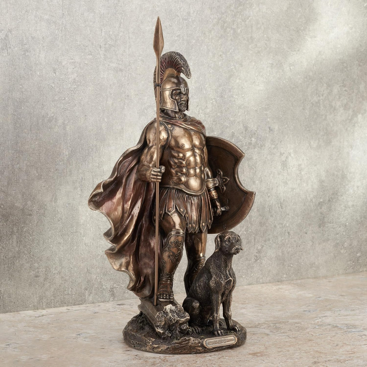 Bronze hued statue of Odysseus in armor with a spear and his dog, Argus