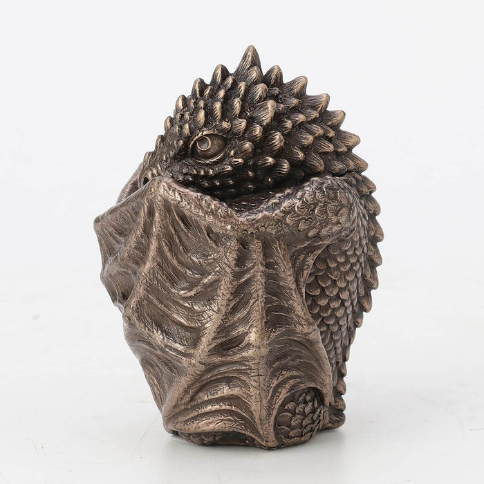 Bronze baby dragon trinket box with wings wrapped around, side view showing eye
