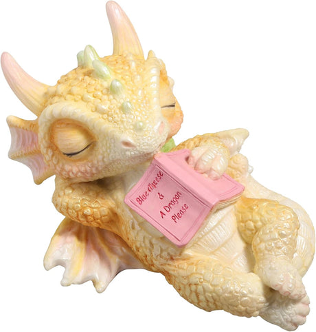 Cute sleeping dragon figurine holding a pink book