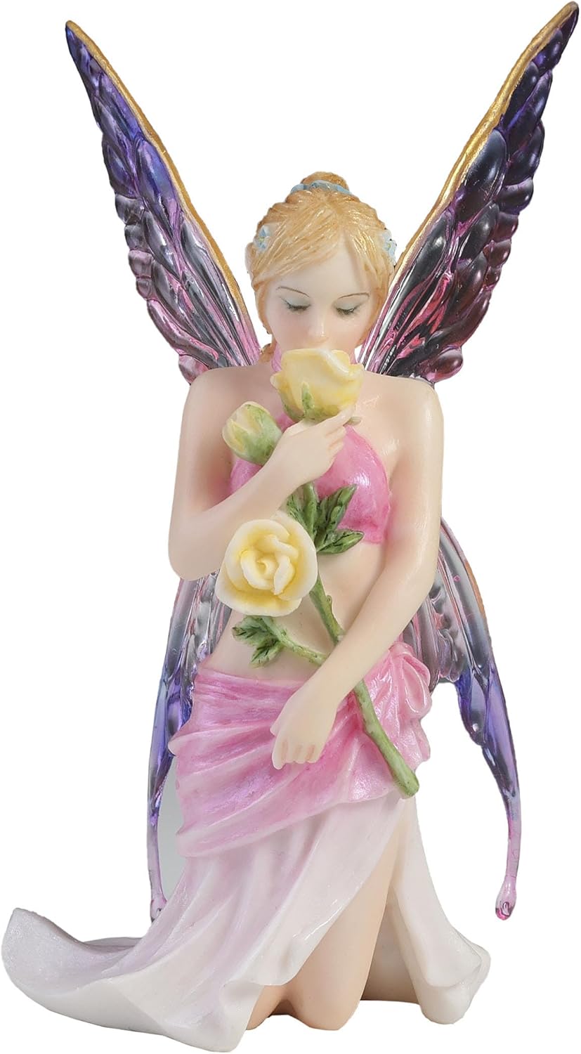 Fairy figurine with pink dress and purple wings holding flowers on a white background