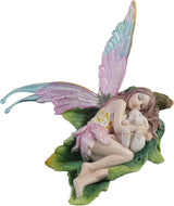 Fairy figurine with colorful wings, cuddling a bunny on a leaf