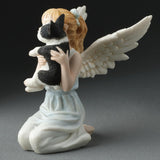 Angel figurine holding a small French Bulldog, shown from the side