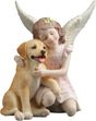 Statue of a girl with angel wings hugging a dog 