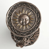 One side of hourglass with sun design