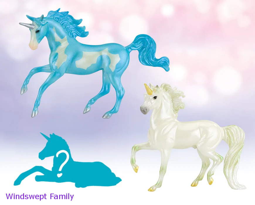 Breyer Unicorn Foal Surprise toy set set with two adult unicorns and hidden foal figurine. Shown models are a blue pinto and a white one, set is the Windswept Family