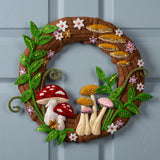 Decorative wreath with mushrooms and flowers on a blue door