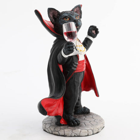 Figurine of black cat in red and black cape, vampire fangs, holding wine glass