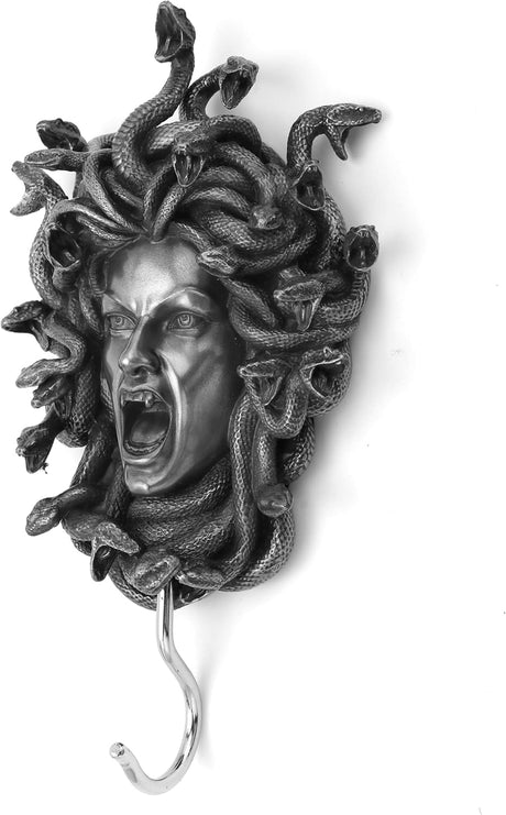 Decorative wall hook shaped like Medusa's head with snakes on a white background